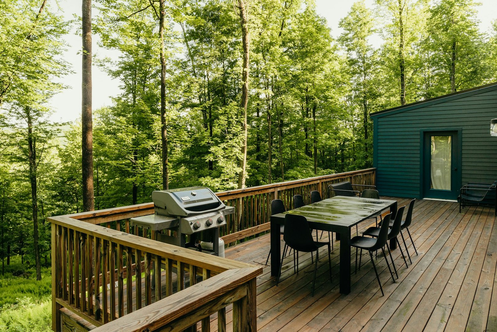 Deck with an outdoor dining table and grill