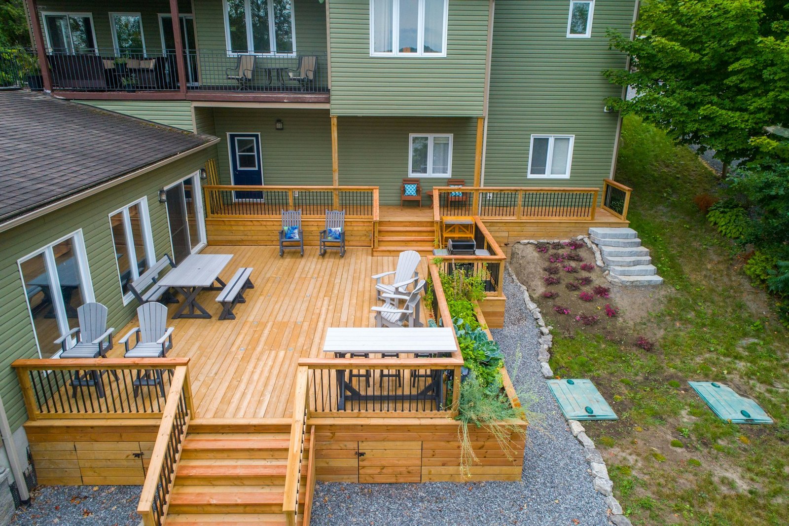 Multi-level cedar deck with stairs on the back of a home